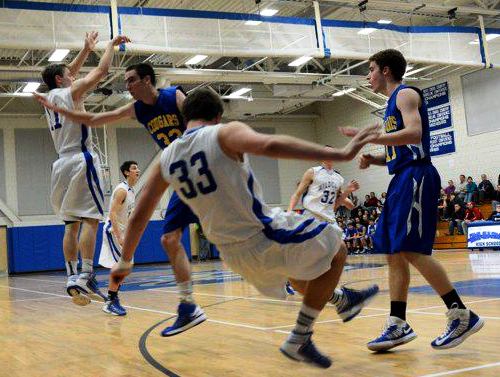 Wildcat senior Slater Gregory takes a tumble while airborne fellow senior Andrew Tyrol shoots for the hoop (Photos by Jen Tyrol)