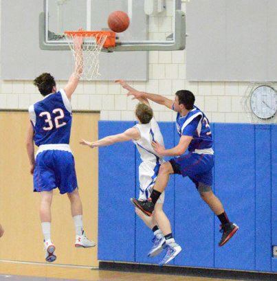 Senior captain Andrew Tyrol (center) will hopefully be leaping high again to score tonight, as in this photo from Saturday's game against Nonnewaug.