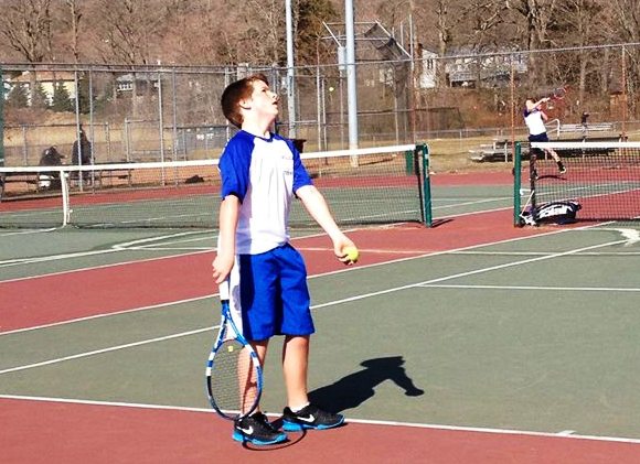 Freshman - and Morgan's younger brother - Brendan White prepares to serve.