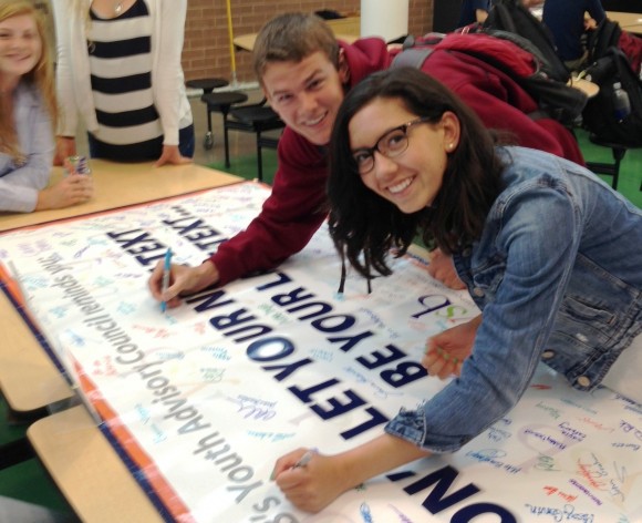 Nora Syed and George Logan sign 'The Pledge.'