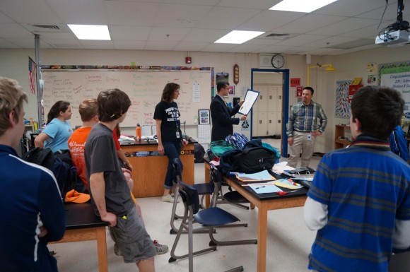 Sen. Art Linares (center) reads an official state citation recognizing the accomplishments of the Lyme-Old Lyme Science Olympiad team for winning the State Championship.  To Sen. Linares’ left is Science Teacher Shannon Glorioso, and at right is Principal Christopher Pomroy.