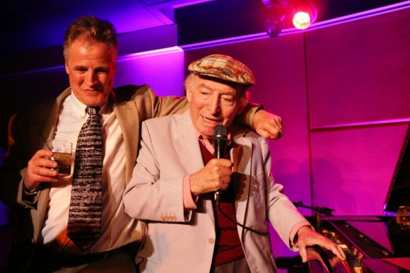 The SideDoor owner Ken Kitchings puts his arm around jazz great George Wein on opening night.