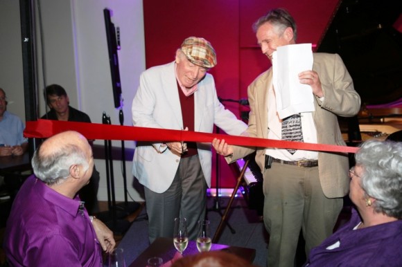 George Wein cuts the ribbon to signify the opening of The Side Door while a delighted Ken Kitchings stands at right. 