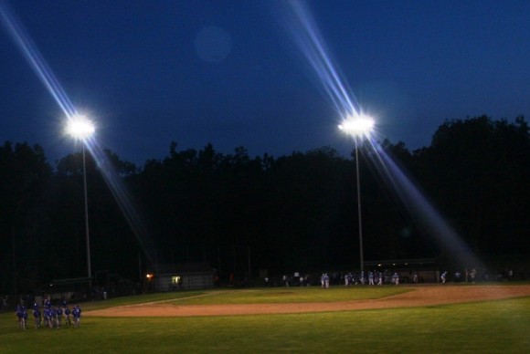 Oxford celebrates their victory while a downcast Old Lyme team gathers to commiserate.