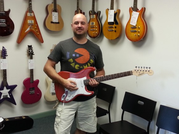 Owner Charles Domler shows off his guitars.