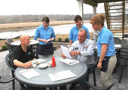 With the Lieutenant River in the background, owner of the property Jim Graybill (right, seated) places his order at the Morning Glory Cafe while Ron Swaney (left) enjoys his breakfast.