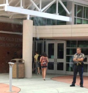 Students enter Lyme-Old Lyme High School on the first day of the new academic year watched over by a member of the OLPD.