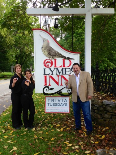 Jason Apfelbaum (right) and two of his staff showing off their motivational poker chips in front of the Old Lyme Inn.