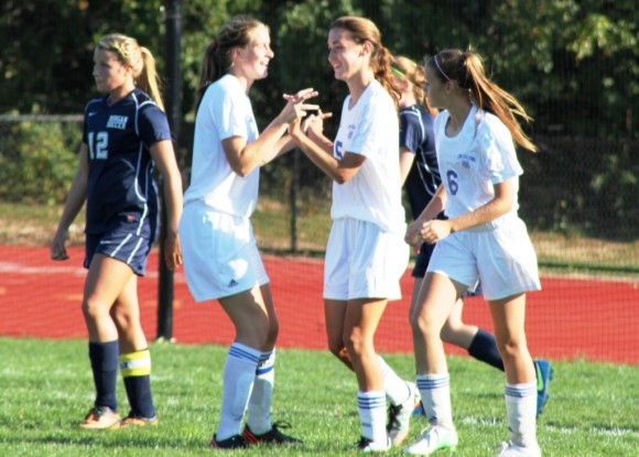 Hanna Behringer and Callie O’Neil congratulate Sam Lee on her goal during the Morgan Game – all three players scored goals during their 5-0 victory.