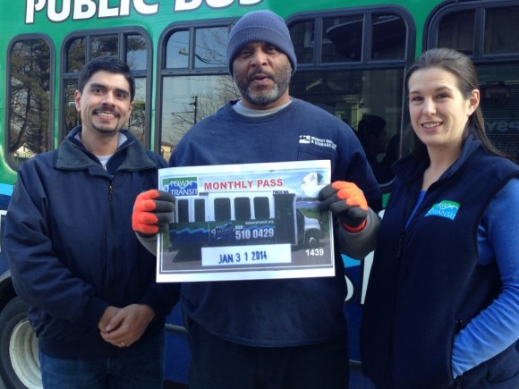 9 Town Transit's 100,000th passenger receives an award of a  free month's bus pass.