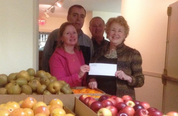 Shoreline Soup Kitchen's Old Lyme Pantry Manager Marie Farrell (front left) with pantry volunteers accepts donation from Laverne Alexander (front right) from The Women's Exchange of Old Lyme.