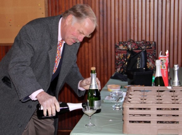 Tim Griswold pours the celebratory champagne.