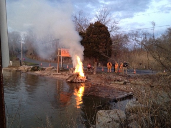 Members of the Old Lyme Fire Department help keep the bonfire under control.