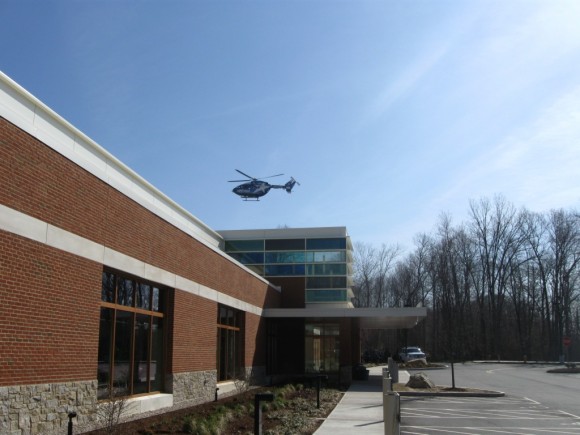 Exterior of Emergency Center with helicopter coming in to land.