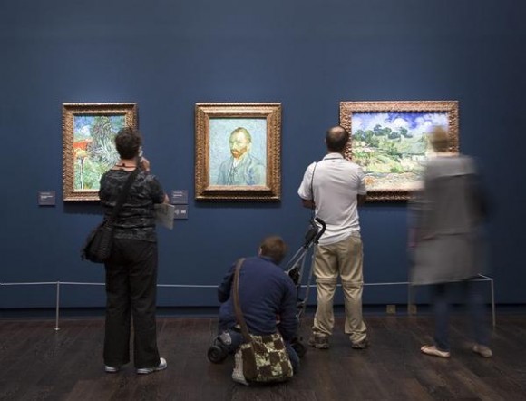 Visitors study the Van Gogh paintings in the new exhibition of the artist's work at the Musee d'Orsay.