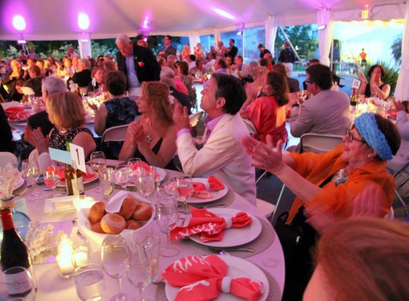 Guests enthusiastically applaud auction winners at last year's ArtsBall.