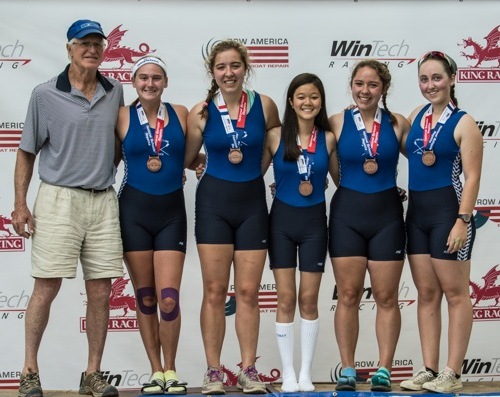 Pictured from left to right are: Coach of the 1st and 2nd Varsity Girls John Laundon, with Ella Pilgrim, Hannah Wilczewski, Kathryn Stedman (coxswain), Hattie Wilczewski and Kaetlin Kolar.