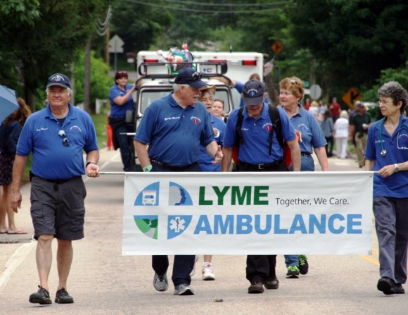 Photo by C. Judy.  Carl Clement (left) accompanied by George Mooney and other members of Lyme Ambulance Department take to the streets.