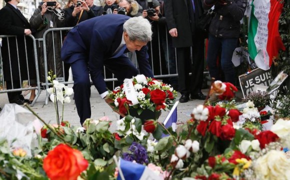 US Foreign Secretary John Kerry pays his respects at the memorial to the Charlie Hebdo victims.
