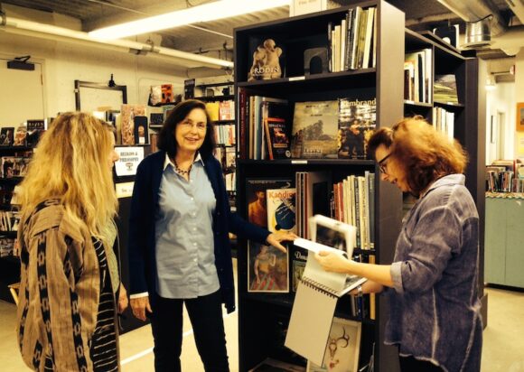 BookCellar co-managers Paulette Zander (left) and Ann de Selding (right) discuss new plans for "the only bookstore in town" with Friends of the Library President Mary Haymann.