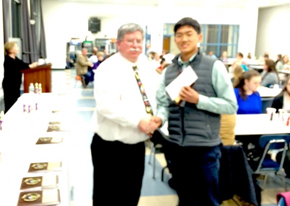 Eric Pan receives his scholarship from the Tresurer of the Math League, Bill Varas of Portland High School.
