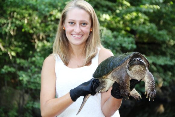 Smile for the camera! Ashley Bright holds a turtle.