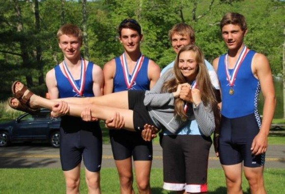 The boys 2nd varsity four pose for a photo wearing their medals with coxswain, from left to right are Jacob Olsen, Peter Fuchs, Bo Green and Adam Drummond holding coxswain Julia Morrison.