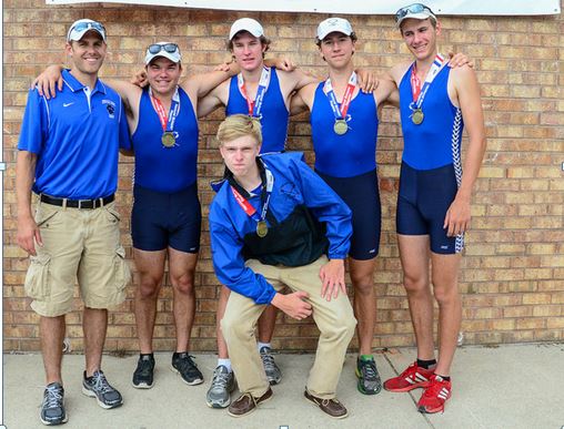 The boy's first boat gather for team photo with coach Louis Zubek and their gold medals. From left to right standing are Josh Swanski, Liam Corrigan, Jeremy "Remy" Newton and Harry Godfrey-Fogg with Thomas Crisp (cox) in front row.