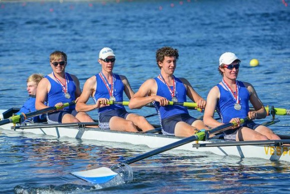 Photo by Brian Corrigan. Rowing away from the award's dock with their silver medals are (from right to left) Liam Corrigan (stroke), Jeremy Newton, Harry Godfrey Fogg, Joshua Swanski and coxswain Tom Crisp.