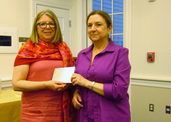 Anne Clement (left), Secretary of the Board of the Friends of the Lyme Public Library presents a check with proceeds from the Friends’ Annual Booksale to Theresa Conley (right), Lyme Public Library Director at the Annual Meeting of the Friends on June 11 at the Library.