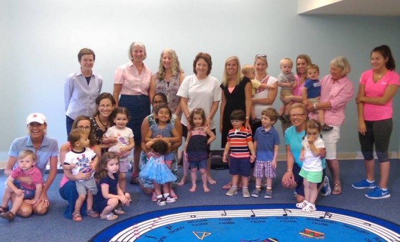 CMS Kindermusik teacher Nancy Thomas is joined by members of the Community Foundation of Middlesex County grants committee and participants in a Pop-Up Day. Photo courtesy of Community Music School.