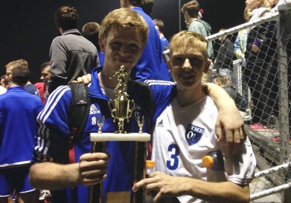 Senior Danny Cole (right) is all smiles as he holds the Shoreline Championship trophy after the Wildcats defeated Morgan 4-0.