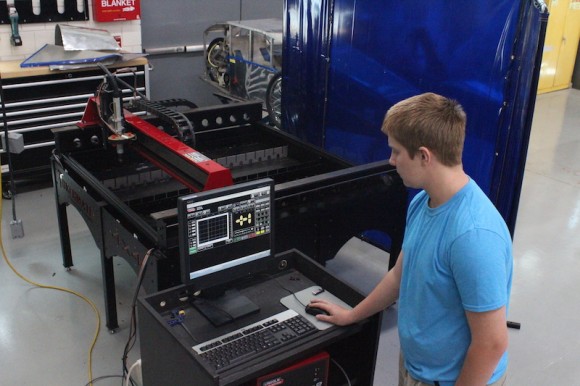 Advanced Engineering and Design student Hunter Thornton at the CNC Plasma Cutter.