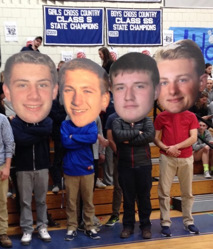 Following a long tradition at Lyme-Old Lyme High School, the seniors pose with oversize cut-outs of their heads used later by the fans to show support for the team.