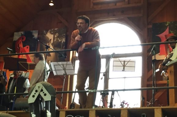 Greg Stroud addresses the audience from the mezzanine level where the musicians played during Sunday's event.