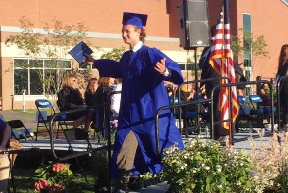 Charlie Dahlke shows his delight after receiving his diploma.