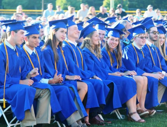 Class members patiently wait for their names to be called to receive their diplomas.