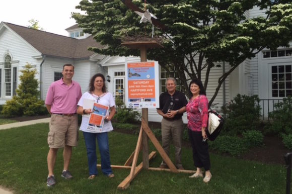 Standing by one of the osprey nests being used to promote this Saturday's Osprey Festival are board members of the Lyme-Old Lyme Chamber of Commerce (from left to right) Mark Griswold, Jan Ayer Cushing, Doug Lo Presti and Joann Lishing.