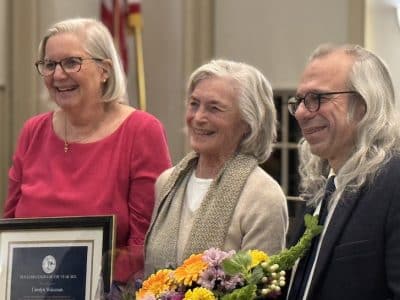 Members of the Board of Selectmen flank honoree Carolyn Wakeman.