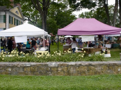 Booths are seen on the grounds in front of the Florence Griswold Museum.